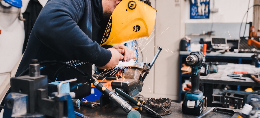 Worker customising metal products